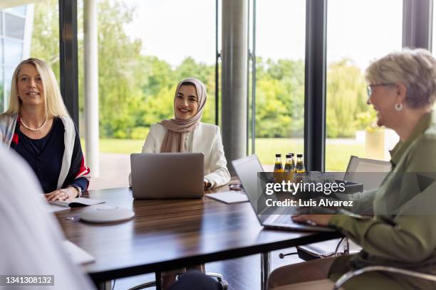 team of multinational professionals in a planning meeting - islam business stock pictures, royalty-free photos & images