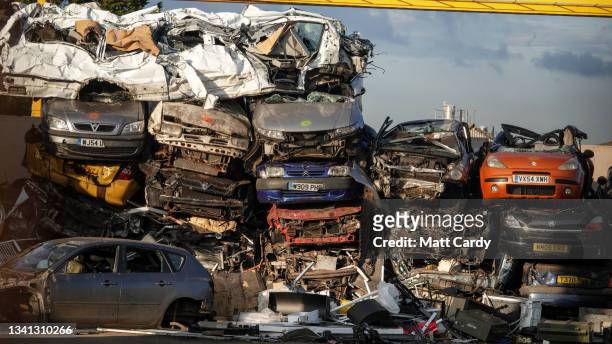 End of life petrol and diesel cars and vans are piled on top of one another as they wait to be recycled in a car scrapyard on September 19, 2021 in...