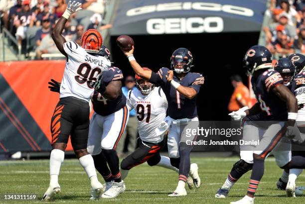 Quarterback Justin Fields of the Chicago Bears throws the ball over defensive end Cameron Sample of the Cincinnati Bengals during the second half at...
