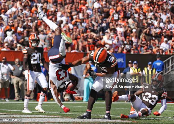 Wide receiver Brandin Cooks of the Houston Texans flips as he makes a catch over outside linebacker Malcolm Smith of the Cleveland Browns during the...