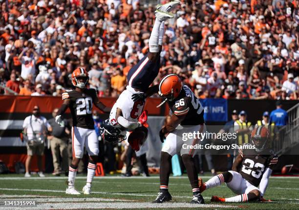 Wide receiver Brandin Cooks of the Houston Texans flips as he makes a catch over outside linebacker Malcolm Smith of the Cleveland Browns during the...