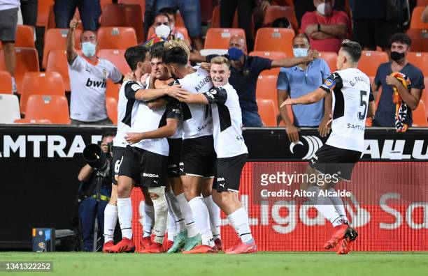 Hugo Duro of Valencia celebrates with teammates after scoring their side's first goal during the La Liga Santander match between Valencia CF and Real...