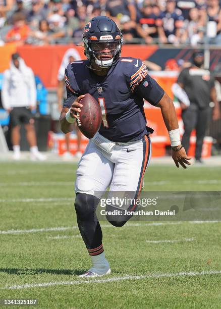 Justin Fields of the Chicago Bears runs for a first down against the Cincinnati Bengals at Soldier Field on September 19, 2021 in Chicago, Illinois....