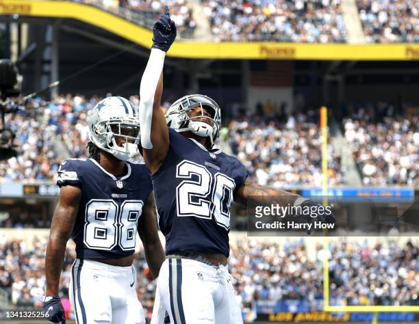 Running back Tony Pollard of the Dallas Cowboys celebrates after a first quarter touchdown in the game against the Los Angeles Chargers at SoFi...
