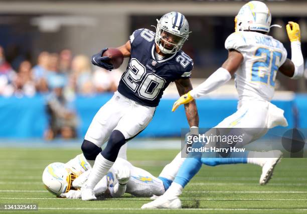 Running back Tony Pollard of the Dallas Cowboys runs the ball during the first quarter in the game against the Los Angeles Chargers at SoFi Stadium...