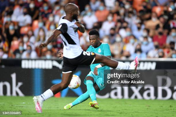 Vinicius Junior of Real Madrid scores their side's first goal during the La Liga Santander match between Valencia CF and Real Madrid CF at Estadio...