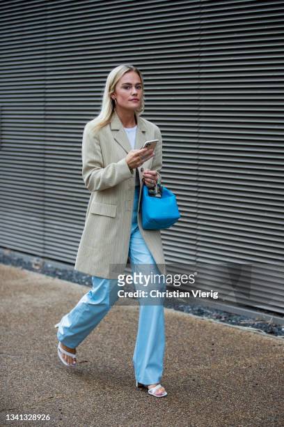 Guest is seen wearing blue pants and bag, blazer outside Rejina Pyo during London Fashion Week September 2021 on September 19, 2021 in London,...