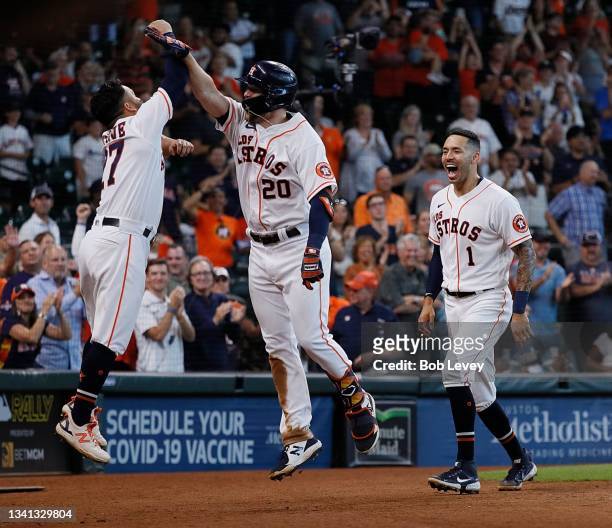 Chas McCormick of the Houston Astros, Jose Altuve and Carlos Correa high five after McCormick's home run in the eighth inning against the Arizona...