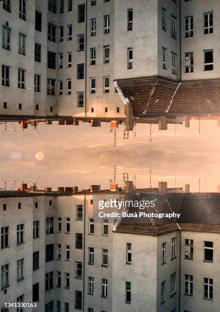 capsized reflected image of rooftops at sunset in berlin, germany - upside down stock pictures, royalty-free photos & images