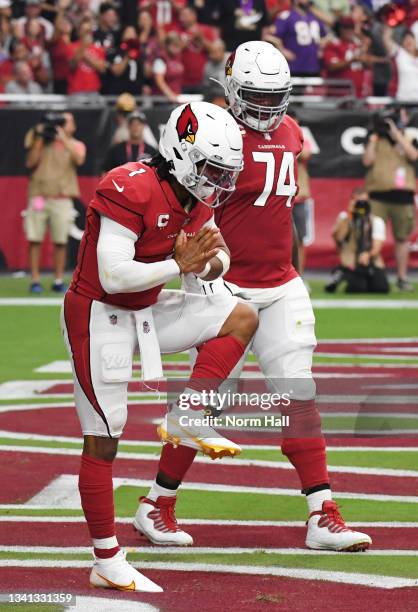 Quarterback Kyler Murray of the Arizona Cardinals celebrates in the end zone after scoring a rushing touchdown against the Minnesota Vikings in the...