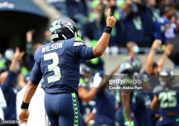 Quarterback Russell Wilson of the Seattle Seahawks reacts to a touchdown in the second quarter in the game against the Tennessee Titans at Lumen...