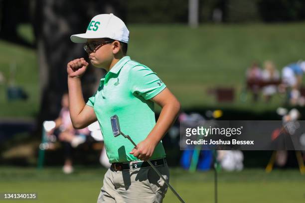 Niko Ameredes reacts after winning the tie breaker putting competition to win first placer overall in the Boys 7-9 division at the Drive, Chip and...