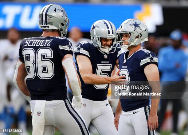 Kicker Greg Zuerlein of the Dallas Cowboys celebrates his game winning field goal with punter Bryan Anger and tight end Dalton Schultz to defeat the...