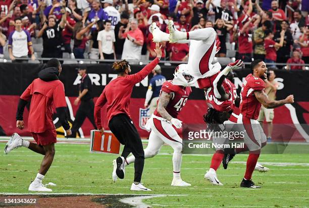 Jonathan Ward of the Arizona Cardinals does a back flip as teammates celebrate on the field after the Minnesota Vikings missed on their game-winning...
