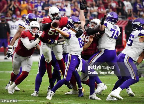 Quarterback Kirk Cousins of the Minnesota Vikings passes under pressure from Chandler Jones of the Arizona Cardinals in the second half of the game...