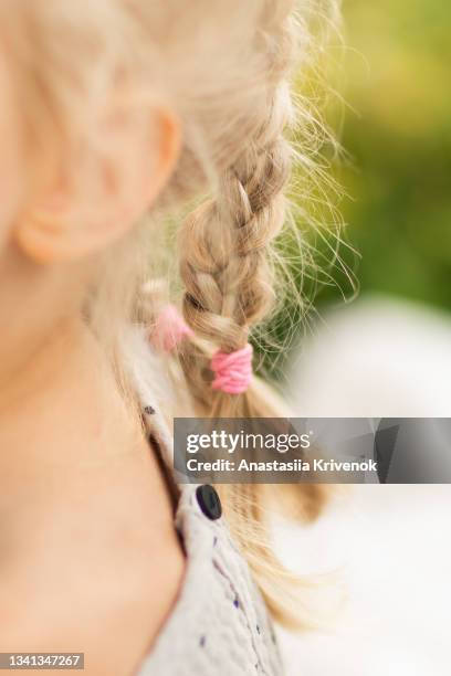 close up of braid hair of little blonde girl. - hair bobble stock pictures, royalty-free photos & images