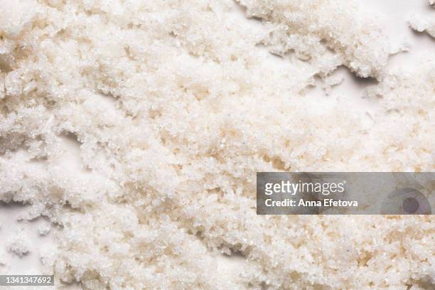 sugar scrub with coconut flakes and oil on white background. concept of body care. flat lay style - coconut white background stock-fotos und bilder