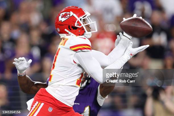 Demarcus Robinson of the Kansas City Chiefs catches a 33-yard touchdown pass from Patrick Mahomes against Marlon Humphrey of the Baltimore Ravens...