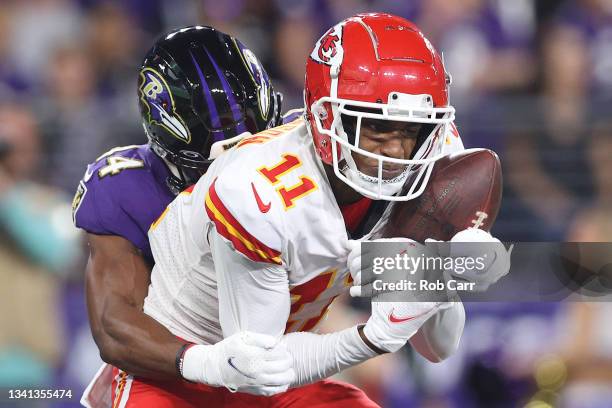 Demarcus Robinson of the Kansas City Chiefs catches a 33-yard touchdown pass from Patrick Mahomes against Marlon Humphrey of the Baltimore Ravens...