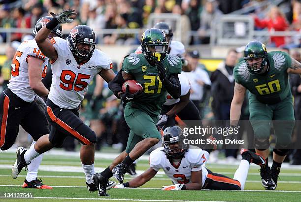 Running back LaMichael James of the Oregon Ducks breaks into the open for a good gain as defensive end Scott Crichton of the Oregon State Beavers...