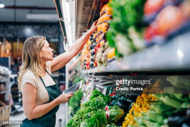 female owner checking inventory at store - super market stock pictures, royalty-free photos & images