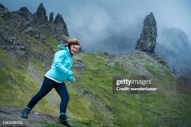 bracing against the wind - old man of storr stock pictures, royalty-free photos & images