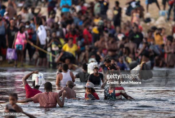 Immigrants, mostly from Haiti gather on the bank of the Rio Grande on September 19, 2021 in Ciudad Acuna, Mexico, across the border from Del Rio,...