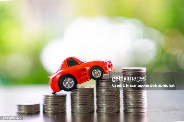 car loan and car insurance concept.,car model with coins - car insurance fotografías e imágenes de stock