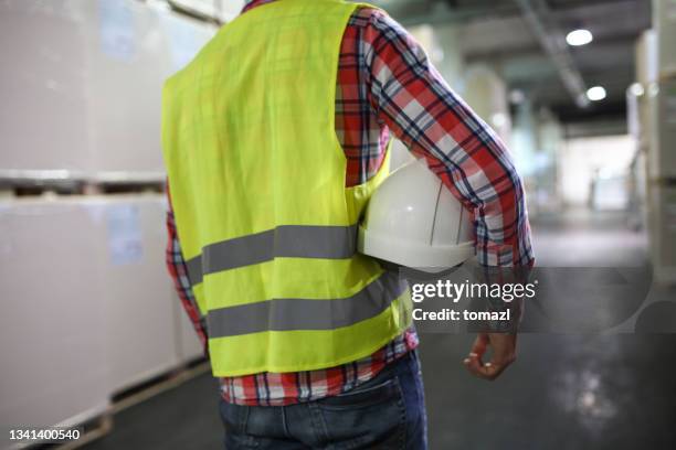 worker in warehouse - waistcoat stock pictures, royalty-free photos & images