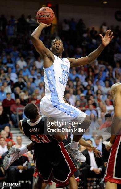 Harrison Barnes of the North Carolina Tar Heels is called for a charge as he shoots against Mike Moser of the UNLV Rebels during the championship...