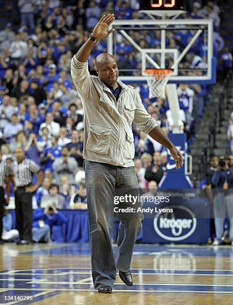 Antoine Walker a former star for the Kentucky Wildcats waves to the crowd during the game against the Portland Pilots at Rupp Arena on November 26,...