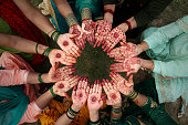 Group of unrecognizable females showing henna hands