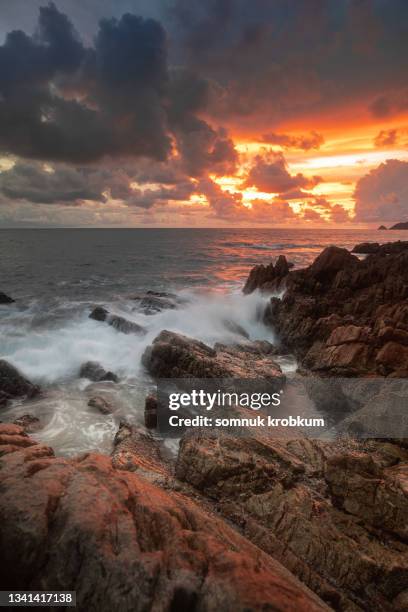 rock coastal and sea in sun set time - waves crashing on rocks stock pictures, royalty-free photos & images