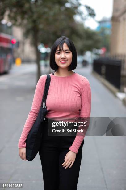 portrait of a young asian woman in the city - filipino girl stock pictures, royalty-free photos & images