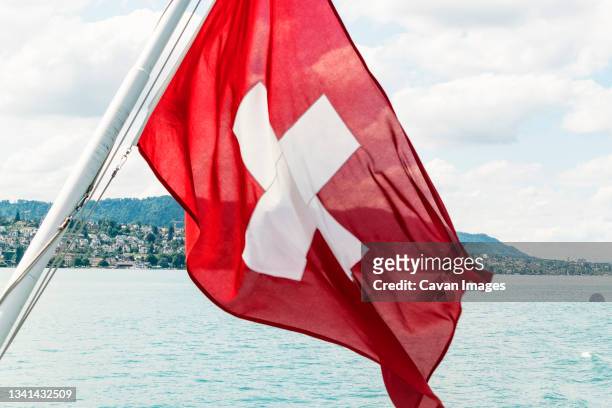 swiss flag on boat, zurich, switzerland - swiss flag stock pictures, royalty-free photos & images
