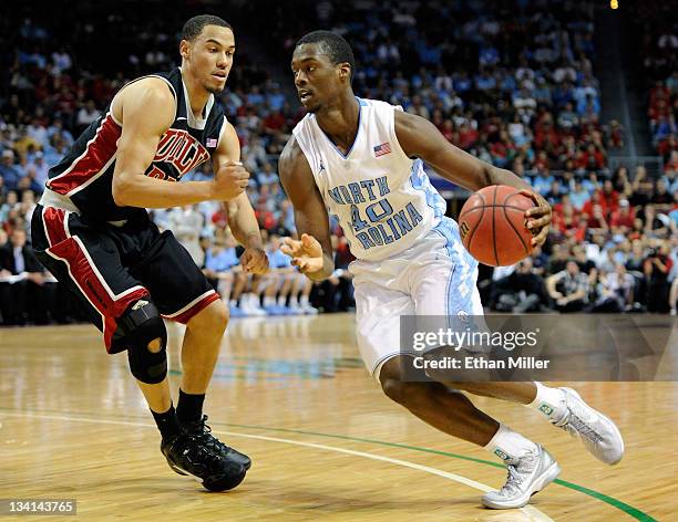 Harrison Barnes of the North Carolina Tar Heels drives against Chace Stanback of the UNLV Rebels during the championship game of the Continental Tire...