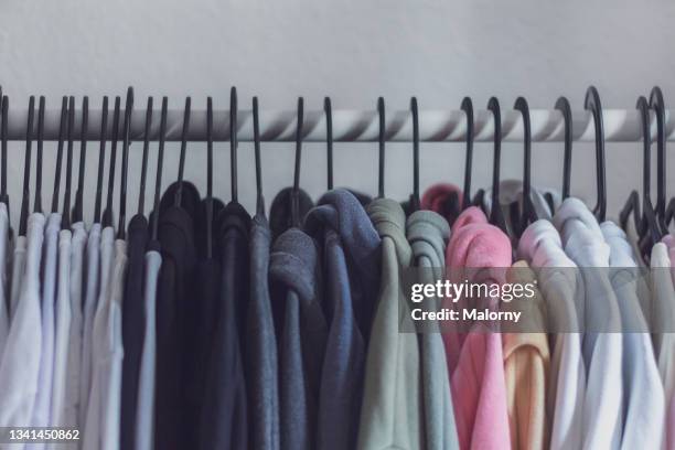 clothes on hangers on a wardrobe. - 服　無人 ストックフォトと画像