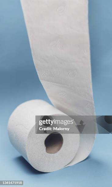 toilet paper on blue background. - wrapped in toilet paper stock pictures, royalty-free photos & images