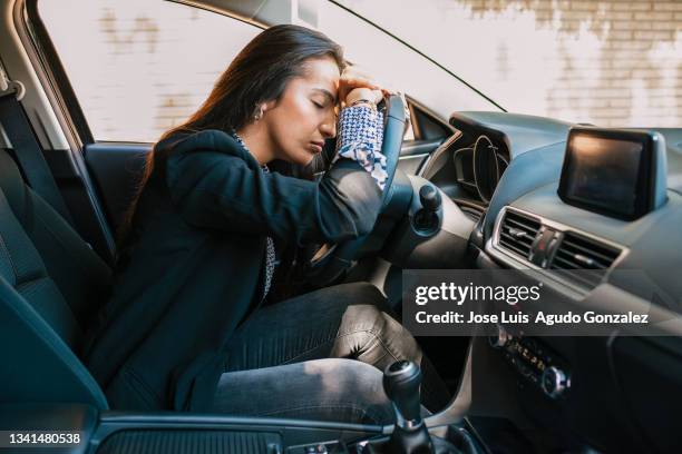 tired woman sleeping in car - sleeping in car stockfoto's en -beelden