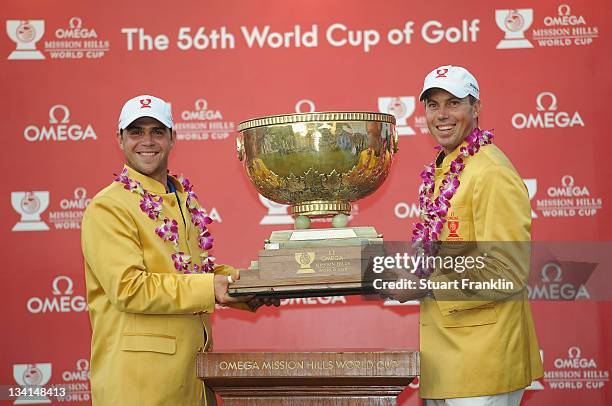 Gary Woodland and Matt Kuchar of USA with the trophy for winning the Omega Mission Hills World Cup at the Mission Hills' Blackstone Course on...