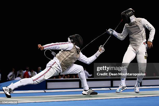 Jamie Davis of Great Britain in action against Tommaso Lari of Italy during the Men's Foil Team Event at the Fencing Invitational, part of the London...