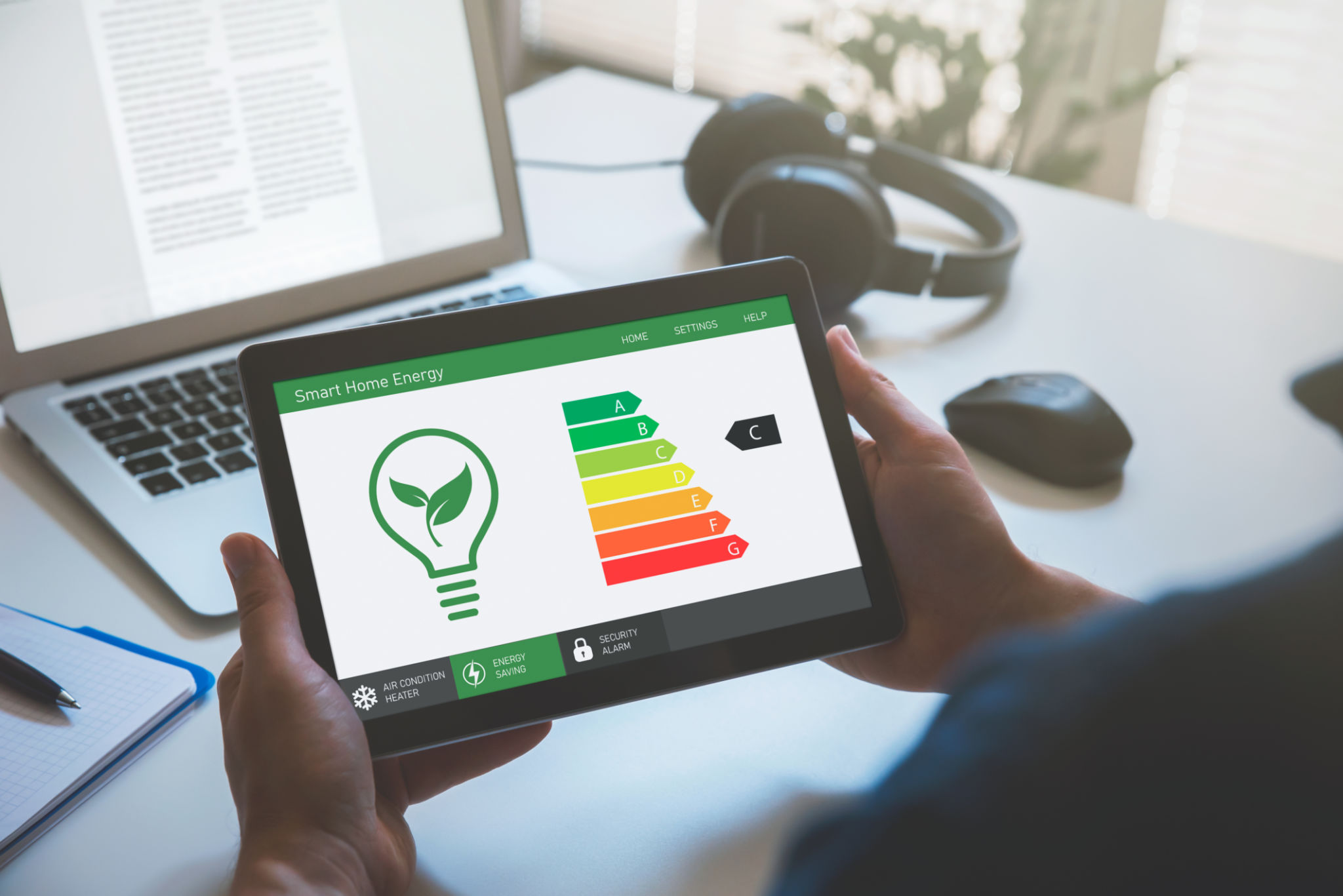 Energy efficiency mobile app on screen, eco house Energy efficiency mobile app on screen, eco house