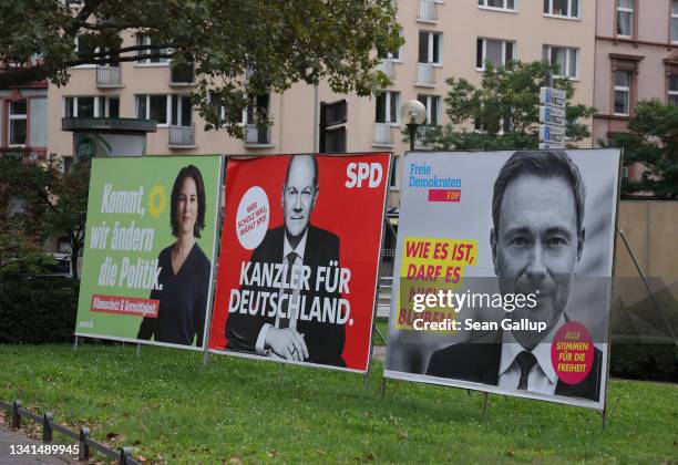 Election campaign billboards showing Annalena Baerbock, chancellor candidate of the German Greens Party, Olaf Scholz, chancellor candidate of the...