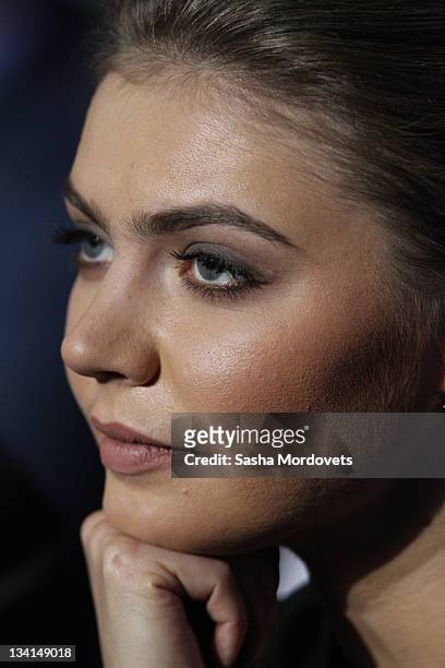 Russian politician and former Olympic Champion, Alina Kabaeva, smiles as Prime Minister Vladimir Putin delivers his speech at the congress of the...