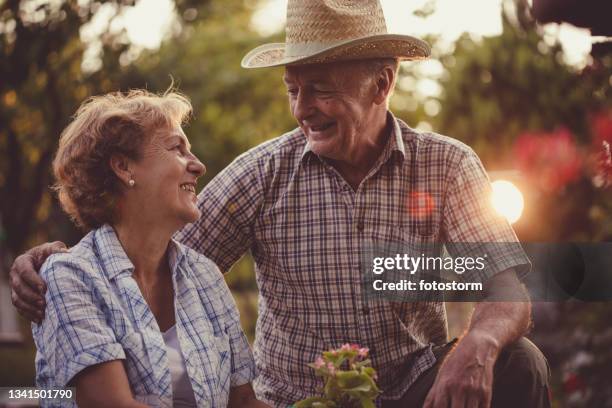 well deserved relaxing years of a retired couple in the garden - 60 69 years imagens e fotografias de stock