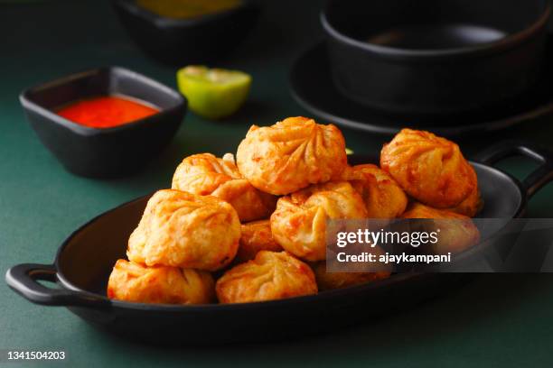 fried momos dumpling - chinese dumpling stock pictures, royalty-free photos & images