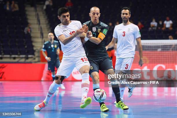 Farhad Tavakoli of Iran is challenged by Leandro Cuzzolino of Argentina during the FIFA Futsal World Cup 2021 group F match between IR Iran and...