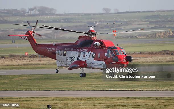 An Irish Coastguard Rescue helicopter leaves RAF Valley as the search continues for the crew of cargo vessel The Swanland which sank off north Wales...