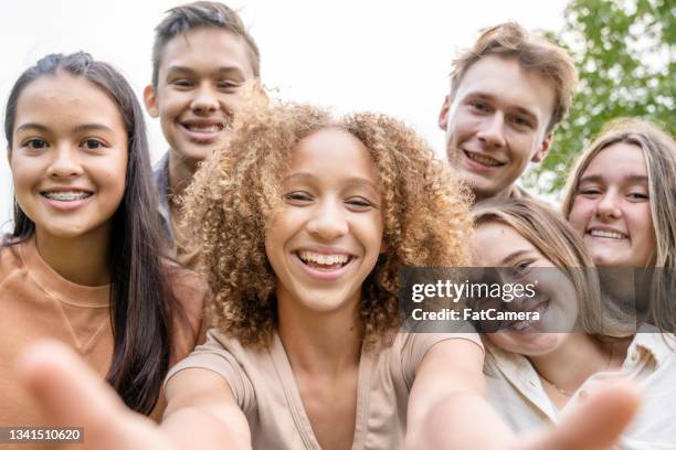 multi-ethnic group of high school students taking a selfie - pre adolescent child stock pictures, royalty-free photos & images