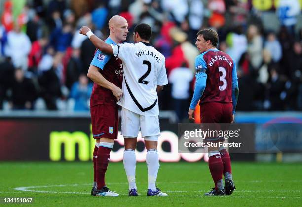 Ashley Williams of Swansea shakes hands with fellow Wales international player James Collins of Aston Villa after the Barclays Premier League match...